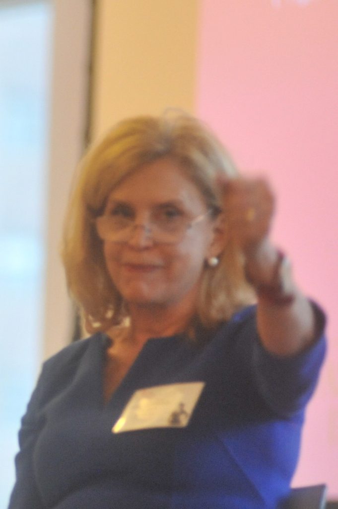 Congresswoman Carolyn Maloney, holding out fist in front of her, starting a fashion revolution!